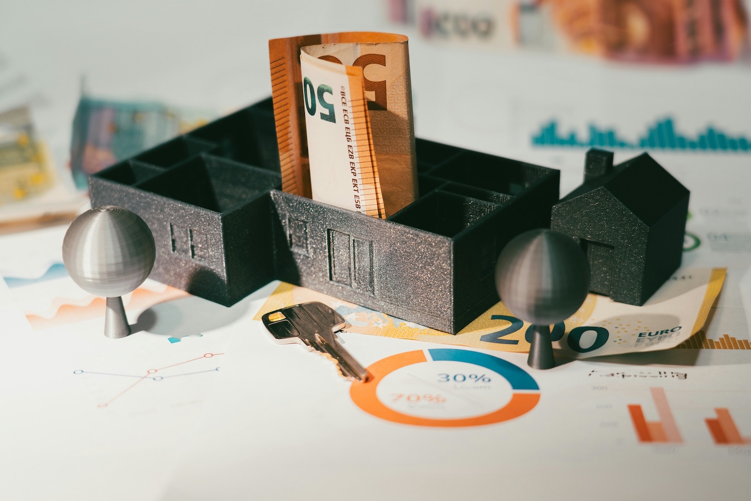 50 euro notes surrounded by items like a model house